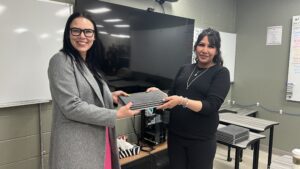 Two women holding certificates